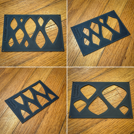 black plastic sheets with different shapes cut out of them