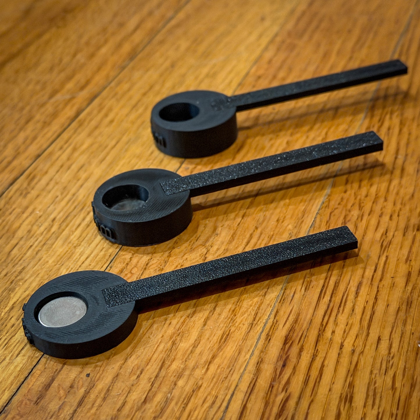 three black plastic tools