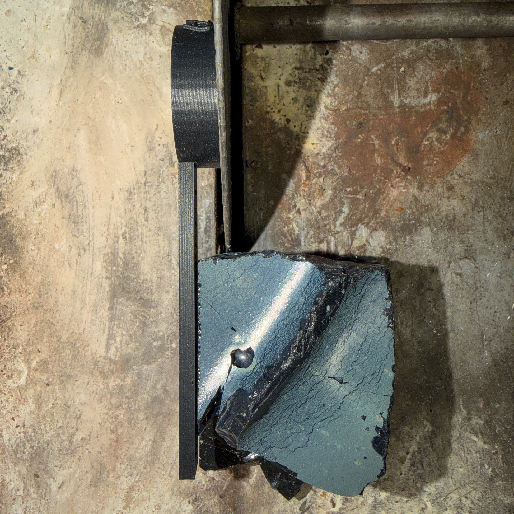 black plastic tool attached to saw blade from above