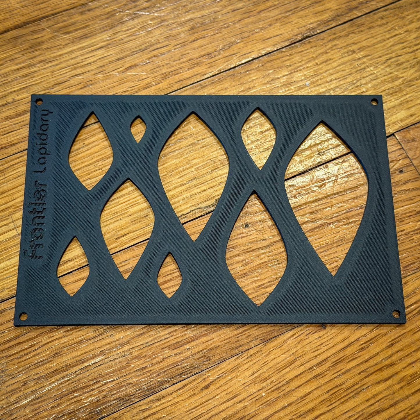 black plastic sheet with shapes cut out